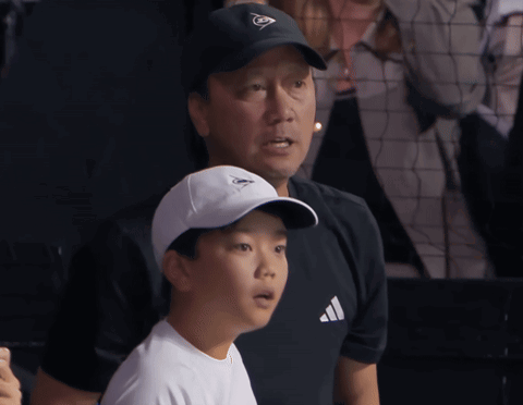 Man in Dunlop Hat With Boy in White Adidas Shirt