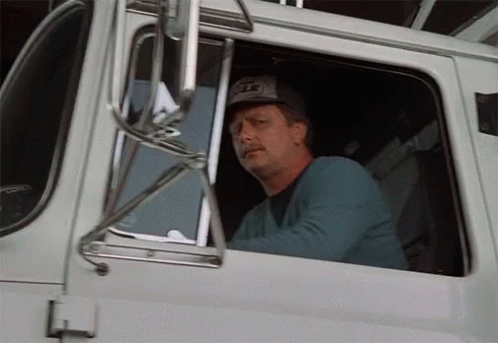 Man in Eagle Hat Driving Truck