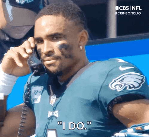 Man In Eagles Jersey Saying I Do On Phone GIF