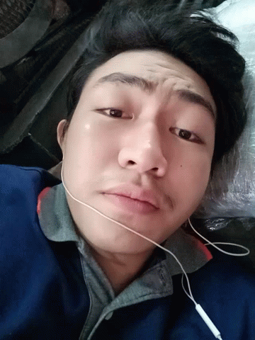 Man in Ear Buds Laying Down Looking