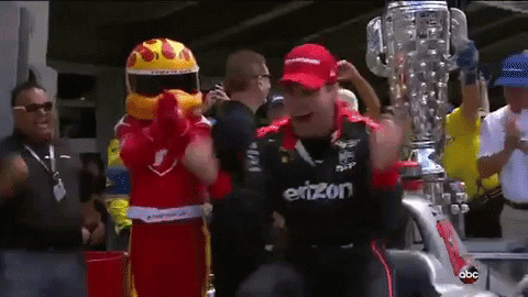 Man In Einzon Shirt Standing Before Trophy GIF