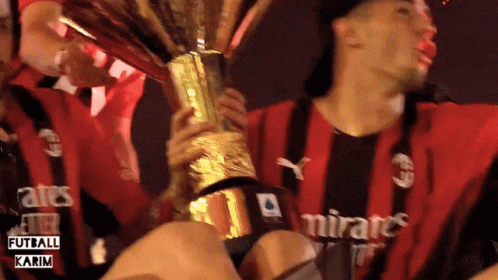 Man In Emirates Shirt Holding Trophy GIF
