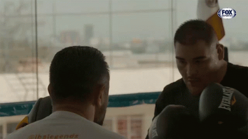 Man in Everlast Boxing Gloves Looking at Another Man