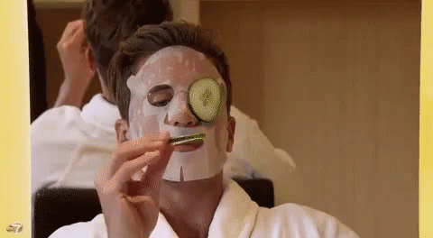 Man in Face Mask With Cucumber on Eye