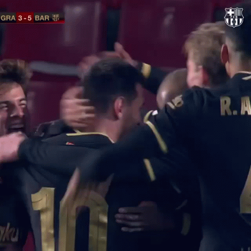 Man in FC Barcelona Jersey Hugging Another Man