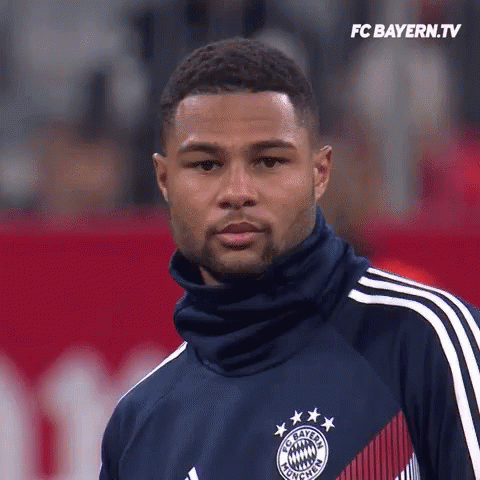 Man in FC Bayern Jersey on Red Field