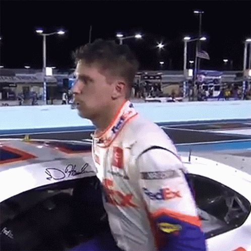 Man in FedEx Racing Suit Sitting in Race Car