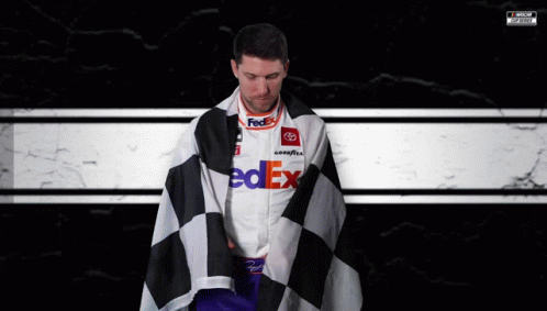 Man In FedEx Shirt Wrapped In Checkered Flag GIF