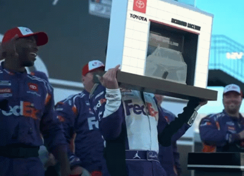 Man in FedEx Uniform Carrying Toyota Sign