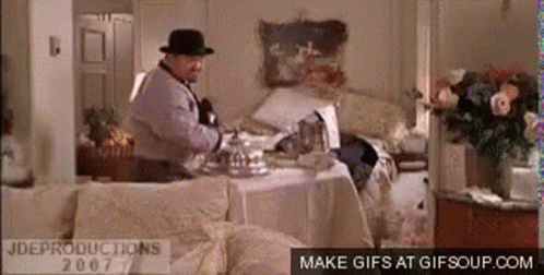 Man In Fedora At Messy Table GIF
