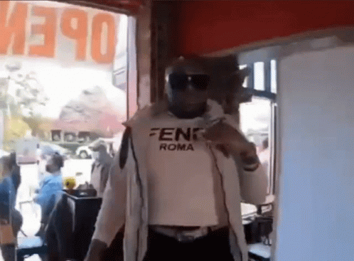 Man in Fendi Roma Shirt at Open Sign