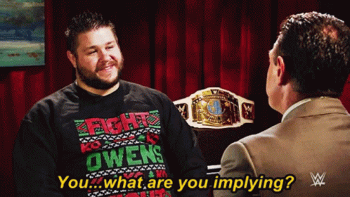 Man in Fight Owens Sweater Talking to Another