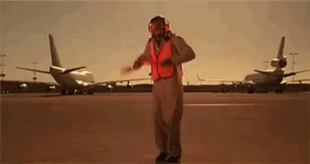 Man in Fighter Jet Costume Dancing on Runway