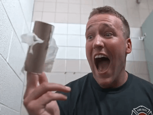 Man in Fire Dept Shirt Holding Toilet Paper