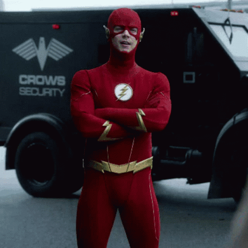 Man in Flash Costume in Front of Crow Security Truck