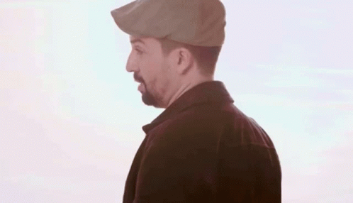 Man In Flat Cap And Black Jacket GIF
