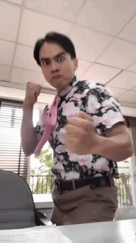 Man In Floral Shirt And Tie Making A Face GIF