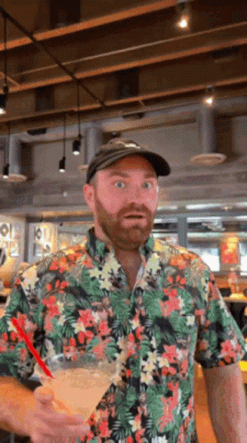 Man In Floral Shirt Holding Drink GIF