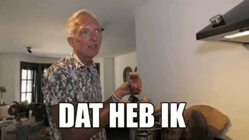 Man in Floral Shirt Holding Glass Dat Heb Ik