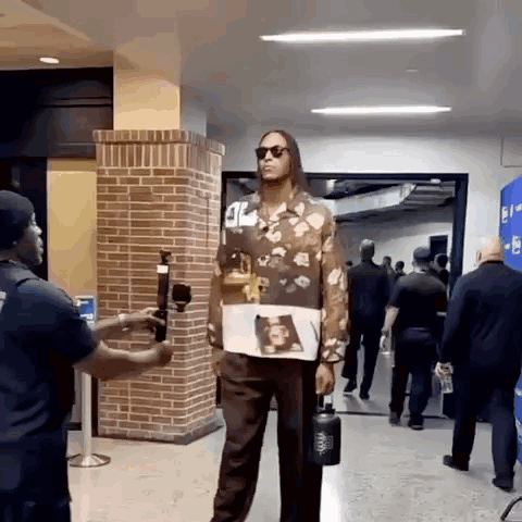 Man In Floral Shirt Holding Water Bottle GIF