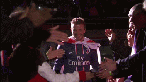 Man in Fly Emirates Jersey in Front of Crowd