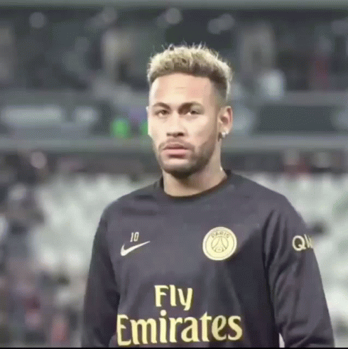 Man in Fly Emirates Jersey Looks at Camera