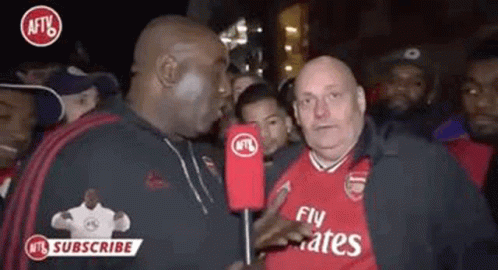 Man in Fly Emirates Shirt Talking