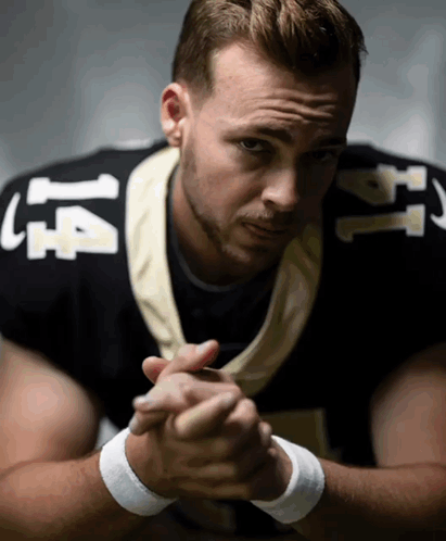 Man in Football Uniform Number 14