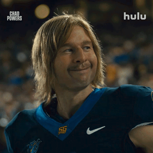 Man in Football Uniform Smiling in Front of Hulu Ad