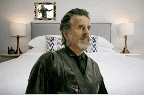 Man in Front of Bed With Picture