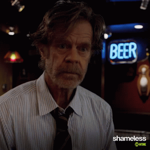 Man in Front of Beer Sign