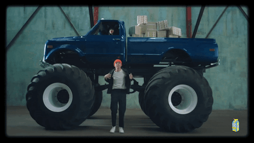 Man in Front of Blue Monster Truck and Milk Carton