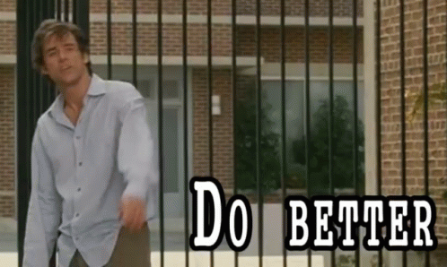 Man in Front of Brick Building Saying Do Better