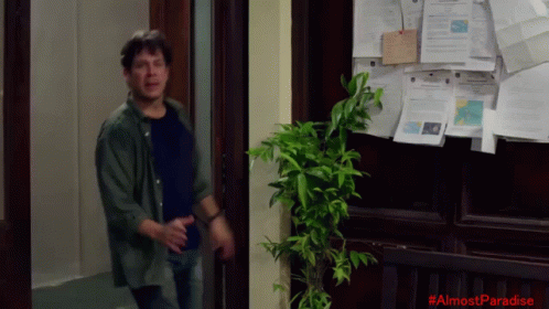 Man In Front Of Bulletin Board Saying Almost Paradise GIF