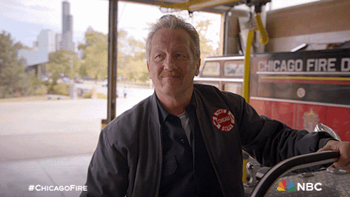 Man In Front Of Chicago Fire Department Vehicle GIF