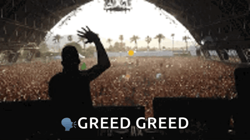 Man in Front of Crowd With Greed Greed