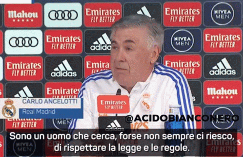 Man in Front of Emirates Advertisements