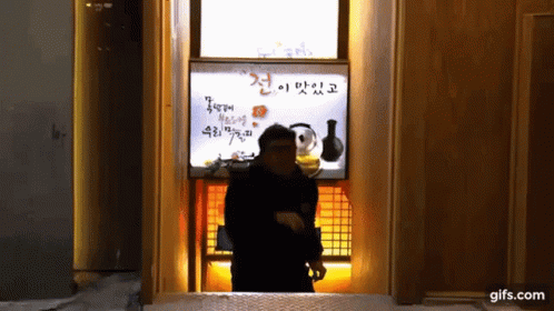 Man In Front Of Gifs.Com Sign