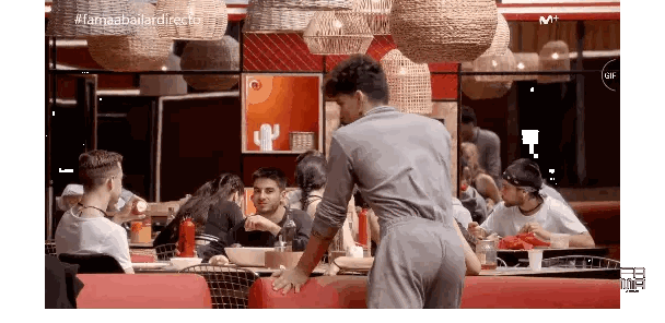 Man in Front of Group in Restaurant with llamaabailardirecto