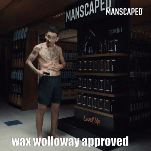 Man In Front Of Manscaped Sign GIF