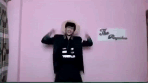 Man in Front of Pink Wall Saying The Republic
