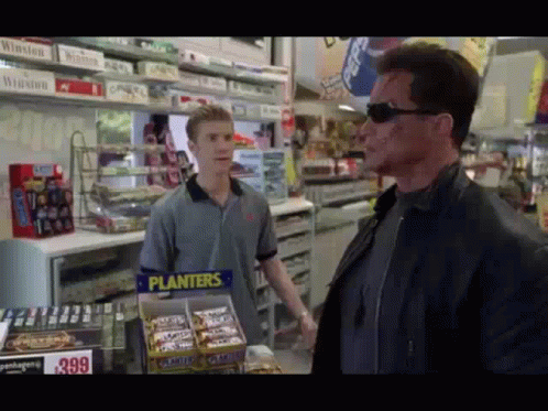 Man in Front of Planters Candy Display