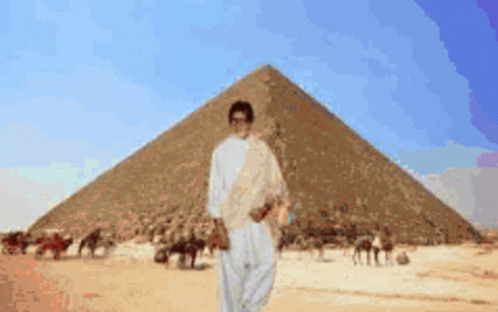 Man in Front of Pyramid in Desert