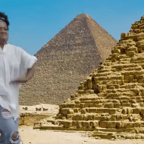 Man in Front of Pyramid in Desert