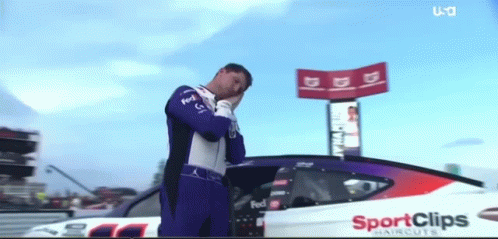 Man in Front of Race Car Saying Sport Clips