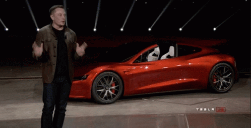 Man In Front Of Red Tesla Model S GIF