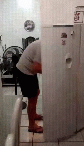 Man in Front of Refrigerator with Strawberry Sticker