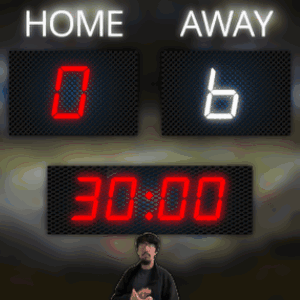 Man in Front of Scoreboard Reading Home Away