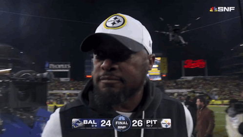 Man in Front of Scoreboard Saying Final 26 Pit