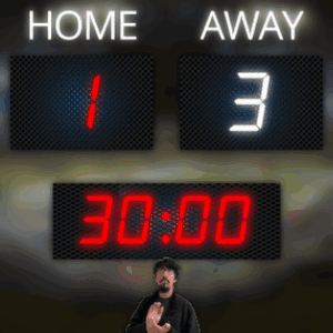 Man in Front of Scoreboard Saying Home Away